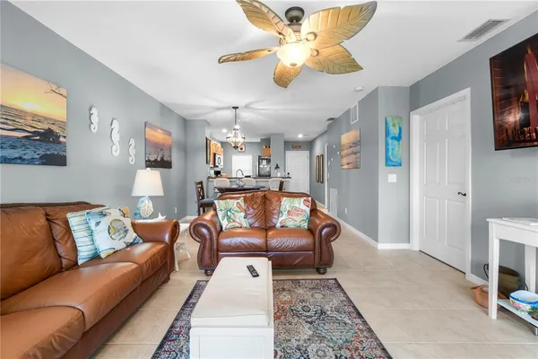 a living room with furniture ceiling fan and a rug