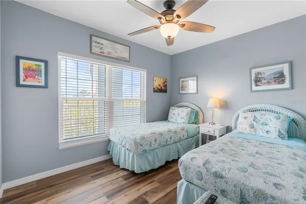 a bedroom with two beds and a window
