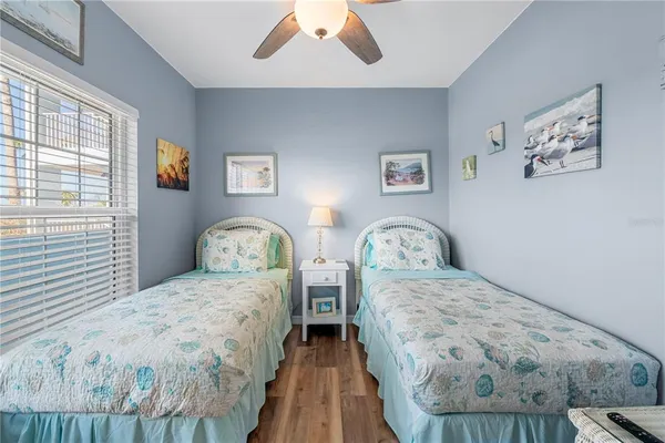 a bedroom with double bed and a wooden floor