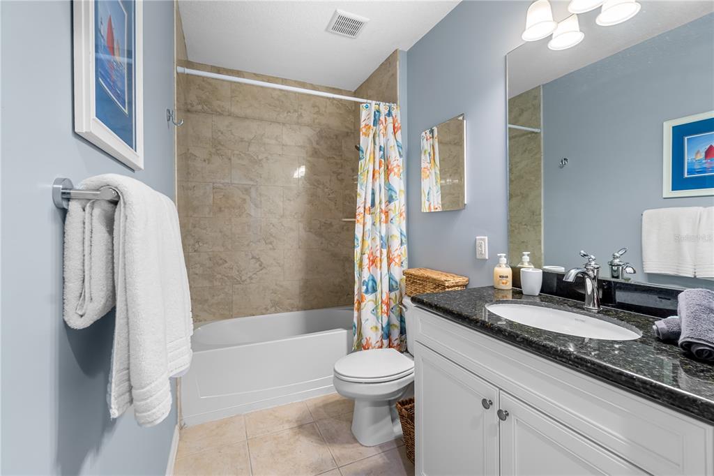 8405 Placida Road, Unit 206 Placida, FL 33946 - Photo 21 of 44 a bathroom with a granite countertop sink toilet and shower