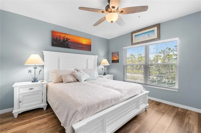 a bedroom with a large bed and a window