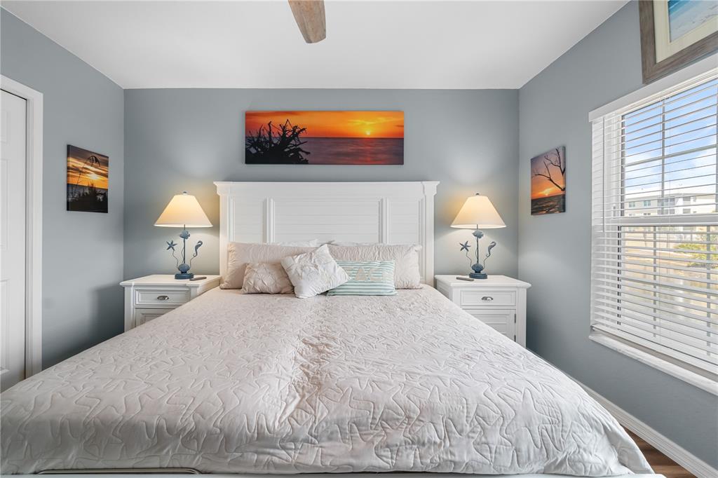 8405 Placida Road, Unit 206 Placida, FL 33946 - Photo 27 of 44 a bedroom with a bed and wooden floor