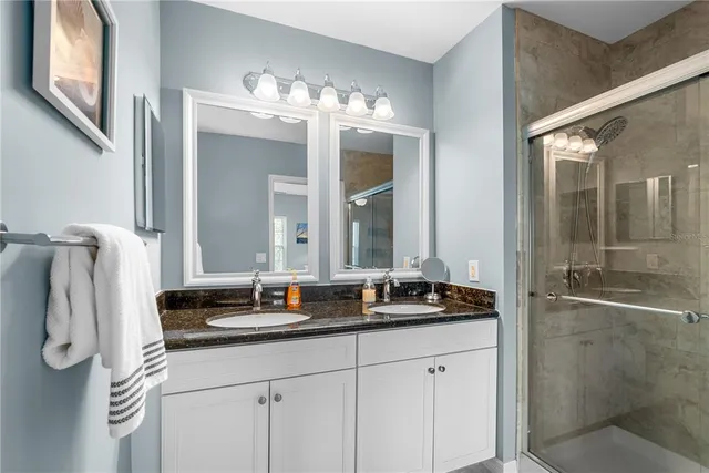 a bathroom with a double vanity sink and mirror