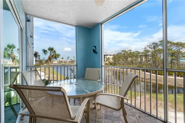 a view of a balcony with a table and chairs