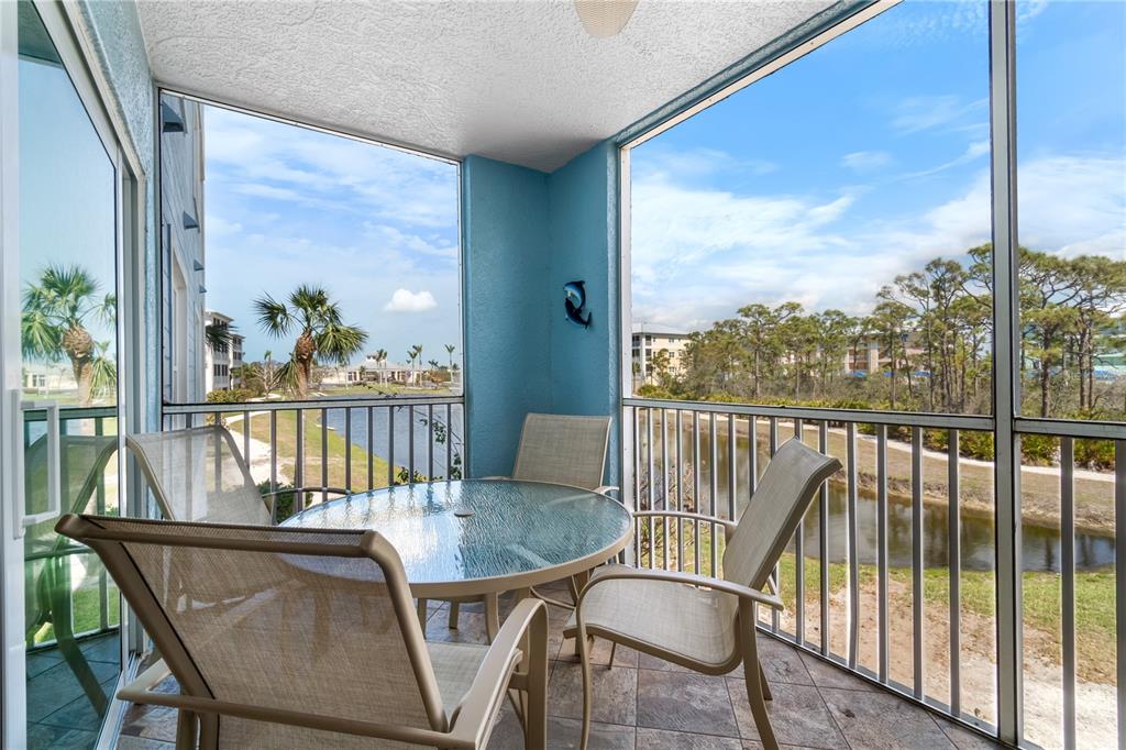 8405 Placida Road, Unit 206 Placida, FL 33946 - Photo 33 of 44 a view of a balcony with a table and chairs