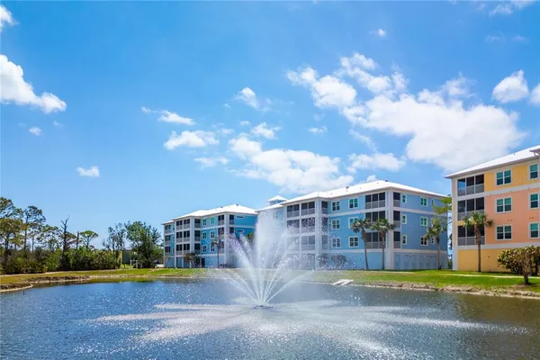 a view of city with tall buildings and trees in the background