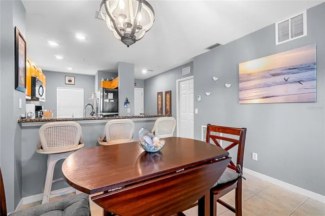 a dining room with furniture and a chandelier