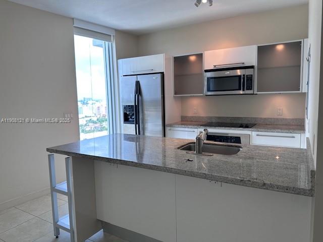 185 Southwest 7th Street, Unit 2300 Miami, FL 33130 - Photo 2 of 9 a kitchen with stainless steel appliances a sink and a microwave