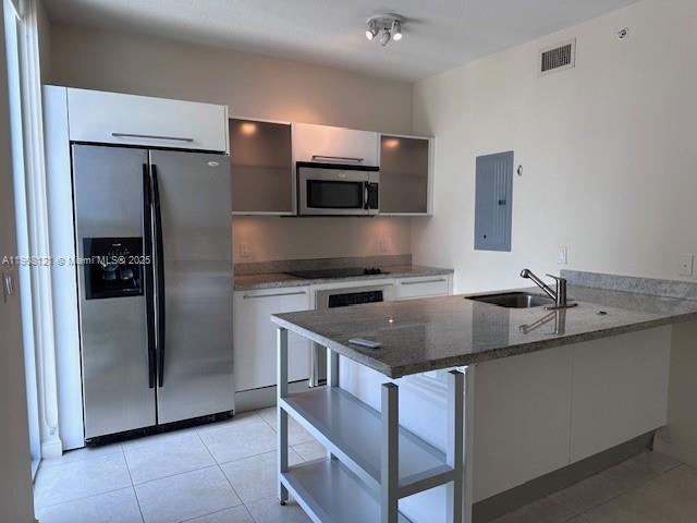 185 Southwest 7th Street, Unit 2300 Miami, FL 33130 - Photo 4 of 9 a kitchen with stainless steel appliances granite countertop a sink stove and refrigerator