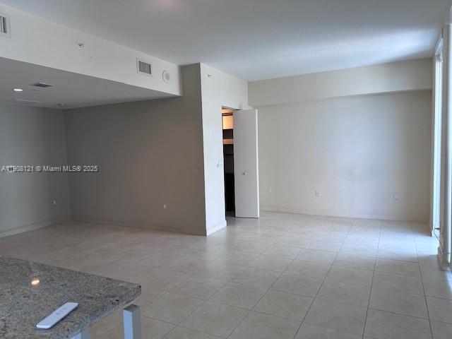 185 Southwest 7th Street, Unit 2300 Miami, FL 33130 - Photo 5 of 9 an empty room with an entryway and fan