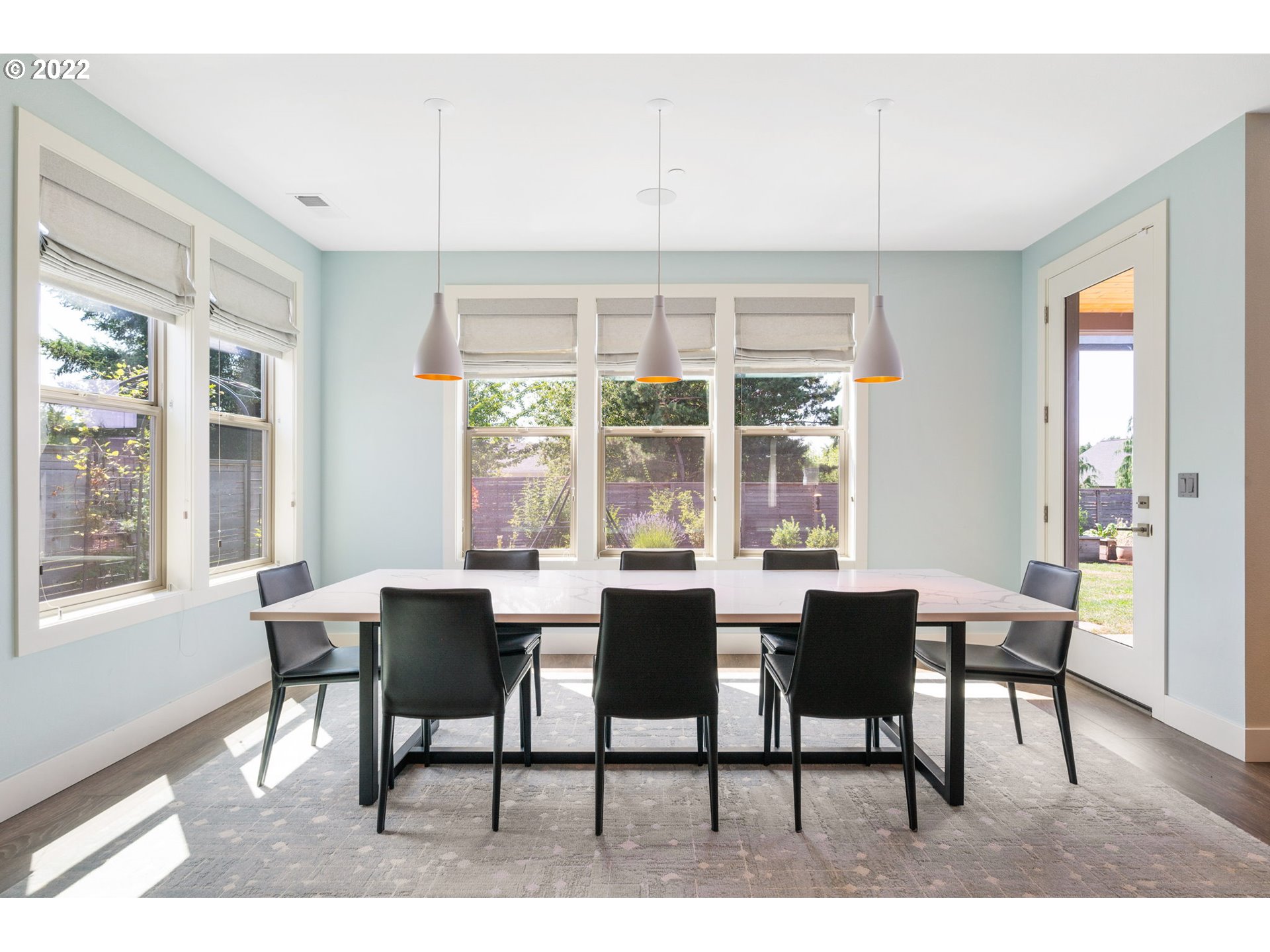 3865 Northwest Celebration Lane Camas, WA 98607 - Photo 11 of 32 a dining room with furniture a chandelier and wooden floor