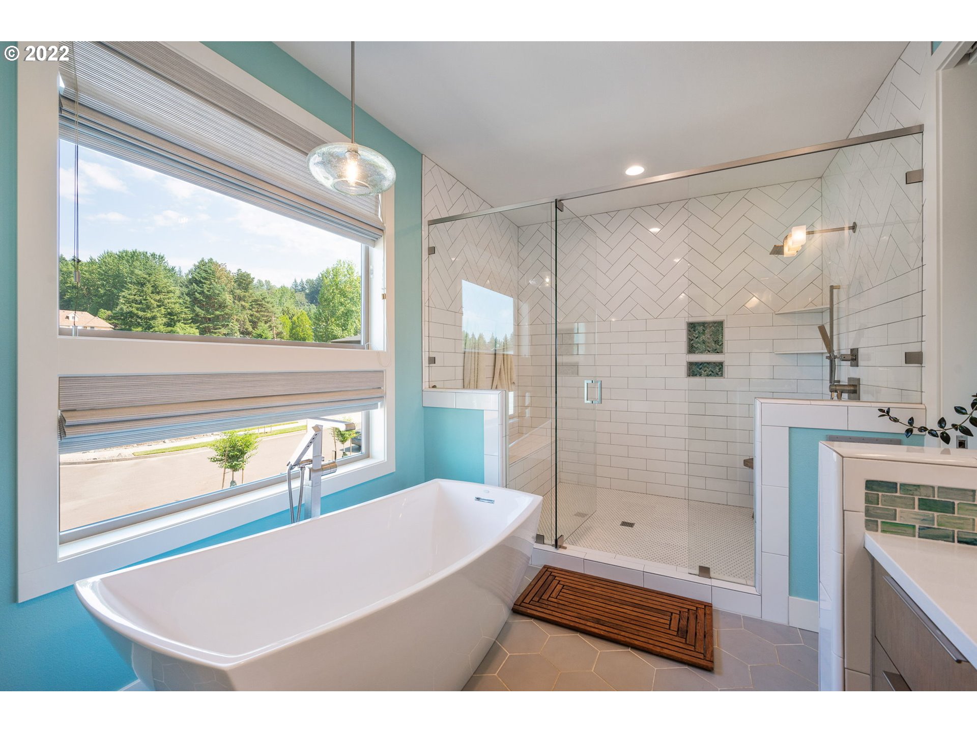3865 Northwest Celebration Lane Camas, WA 98607 - Photo 18 of 32 a bathroom with a bathtub a sink a mirror and a shower