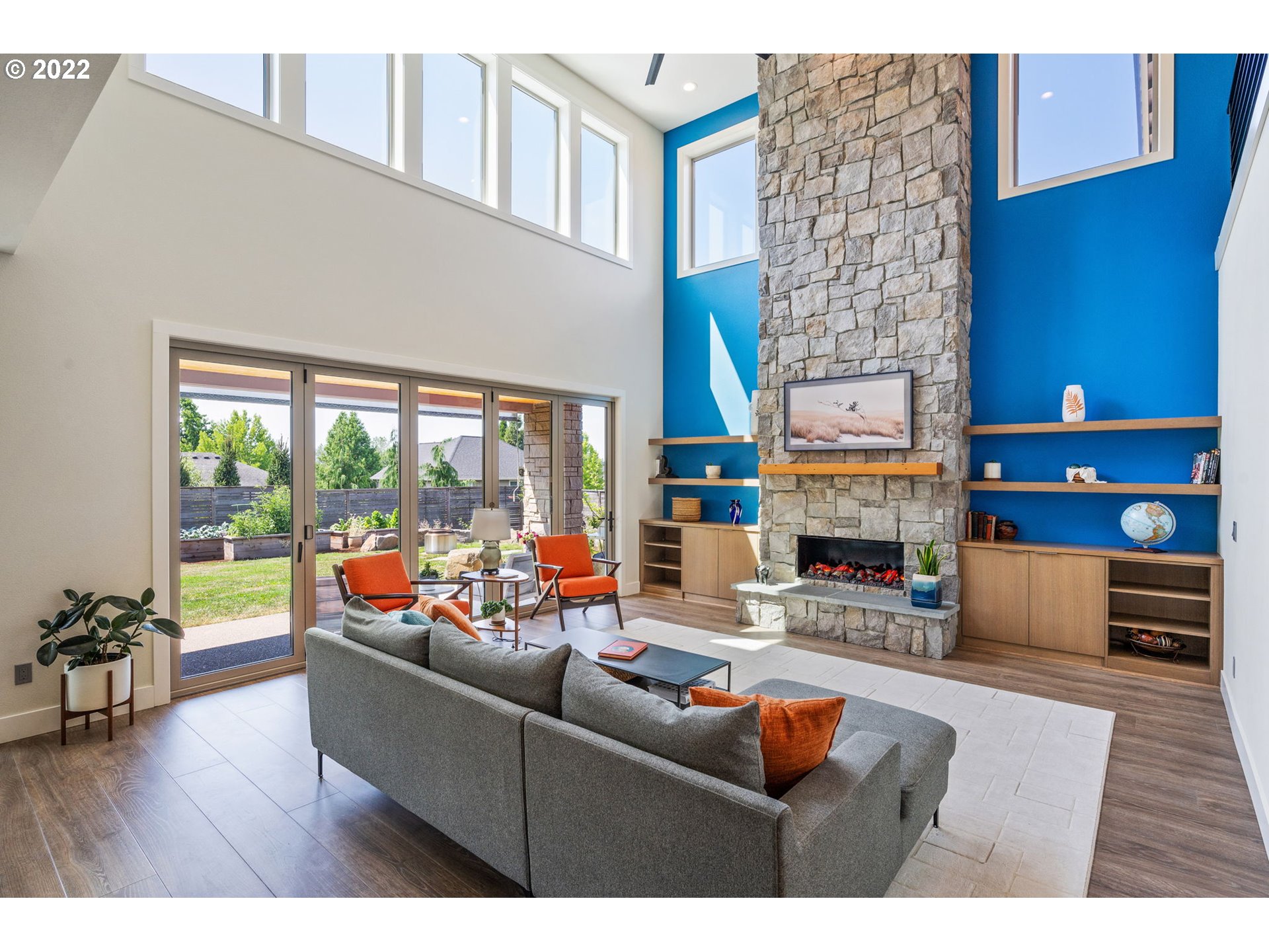 3865 Northwest Celebration Lane Camas, WA 98607 - Photo 5 of 32 a living room with fireplace furniture and a floor to ceiling window