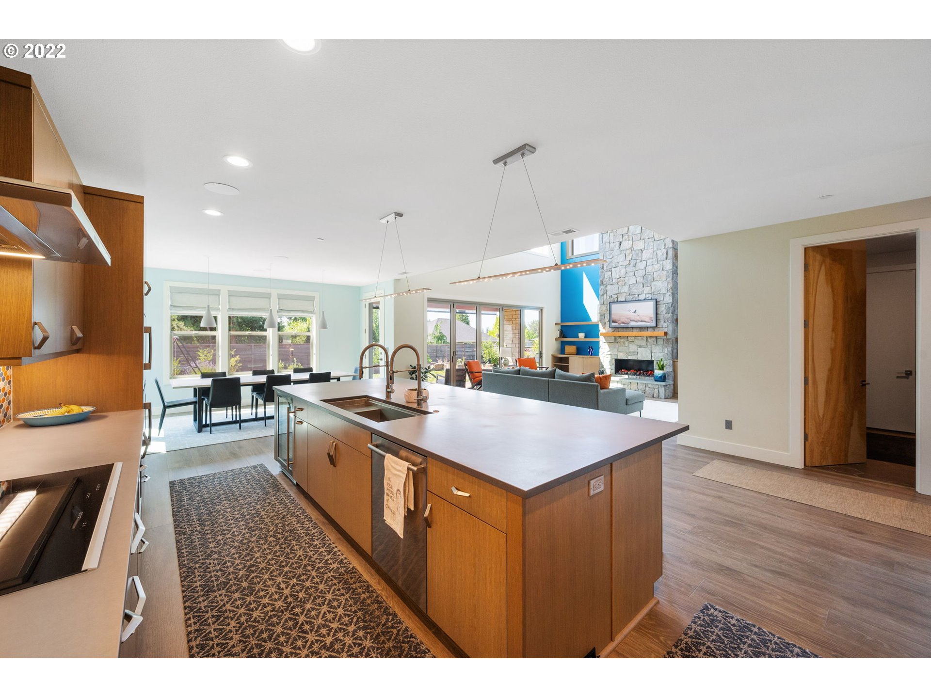 3865 Northwest Celebration Lane Camas, WA 98607 - Photo 10 of 32 a kitchen with kitchen island a sink and wooden floor