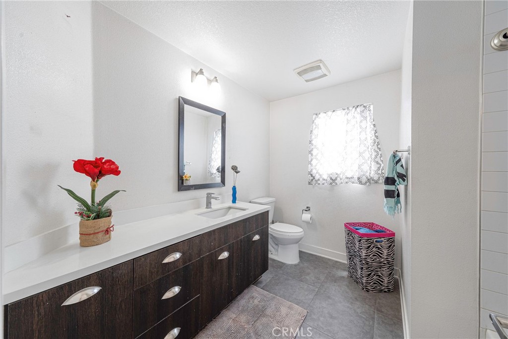 2976 Ripple Place, Unit 201 Los Angeles, CA 90039 - Photo 14 of 19 a bathroom with a sink vanity mirror and toilet