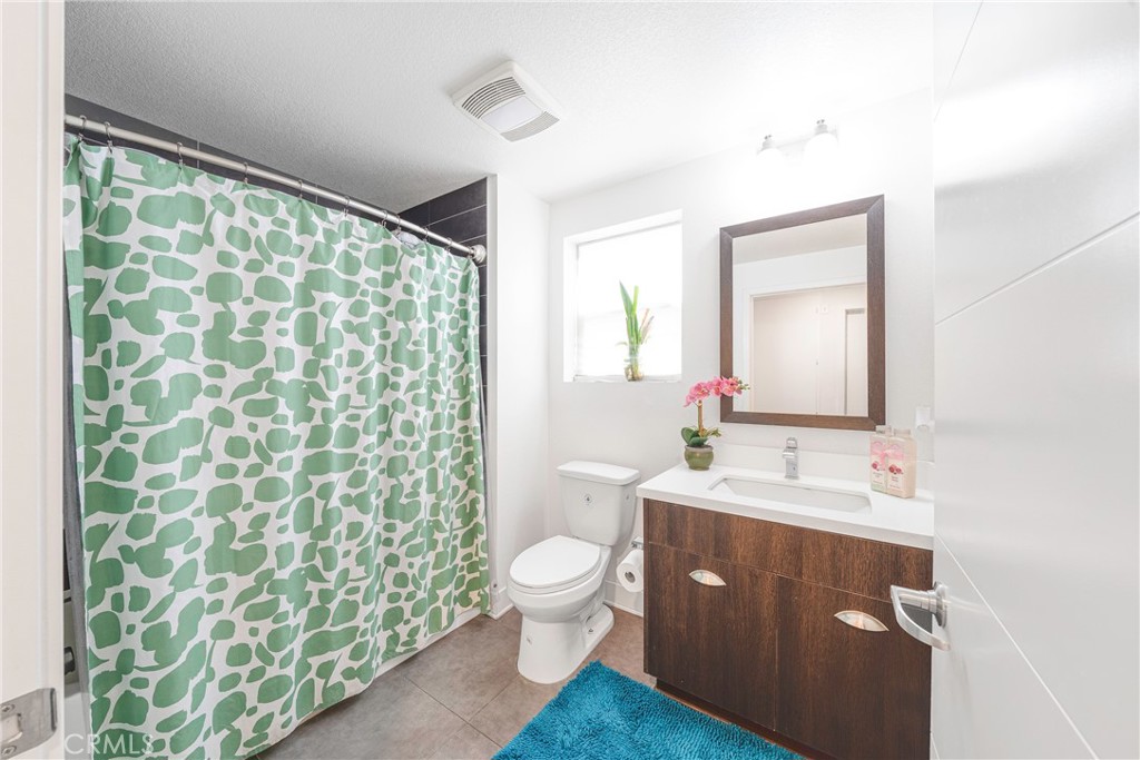 2976 Ripple Place, Unit 201 Los Angeles, CA 90039 - Photo 9 of 19 a bathroom with a double vanity sink toilet and a mirror