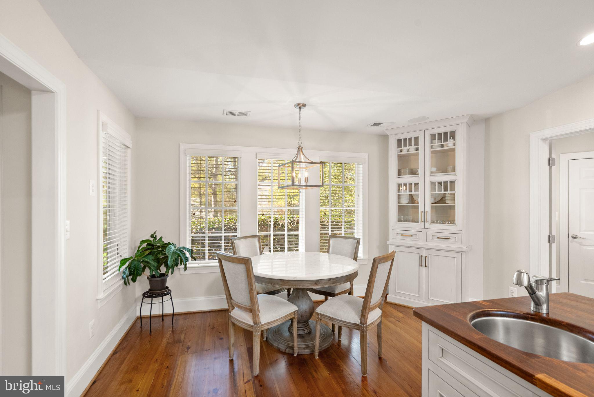 11809 Wayland Street Oakton, VA 22124 - Photo 32 of 97 a kitchen with a table chairs and a potted plant