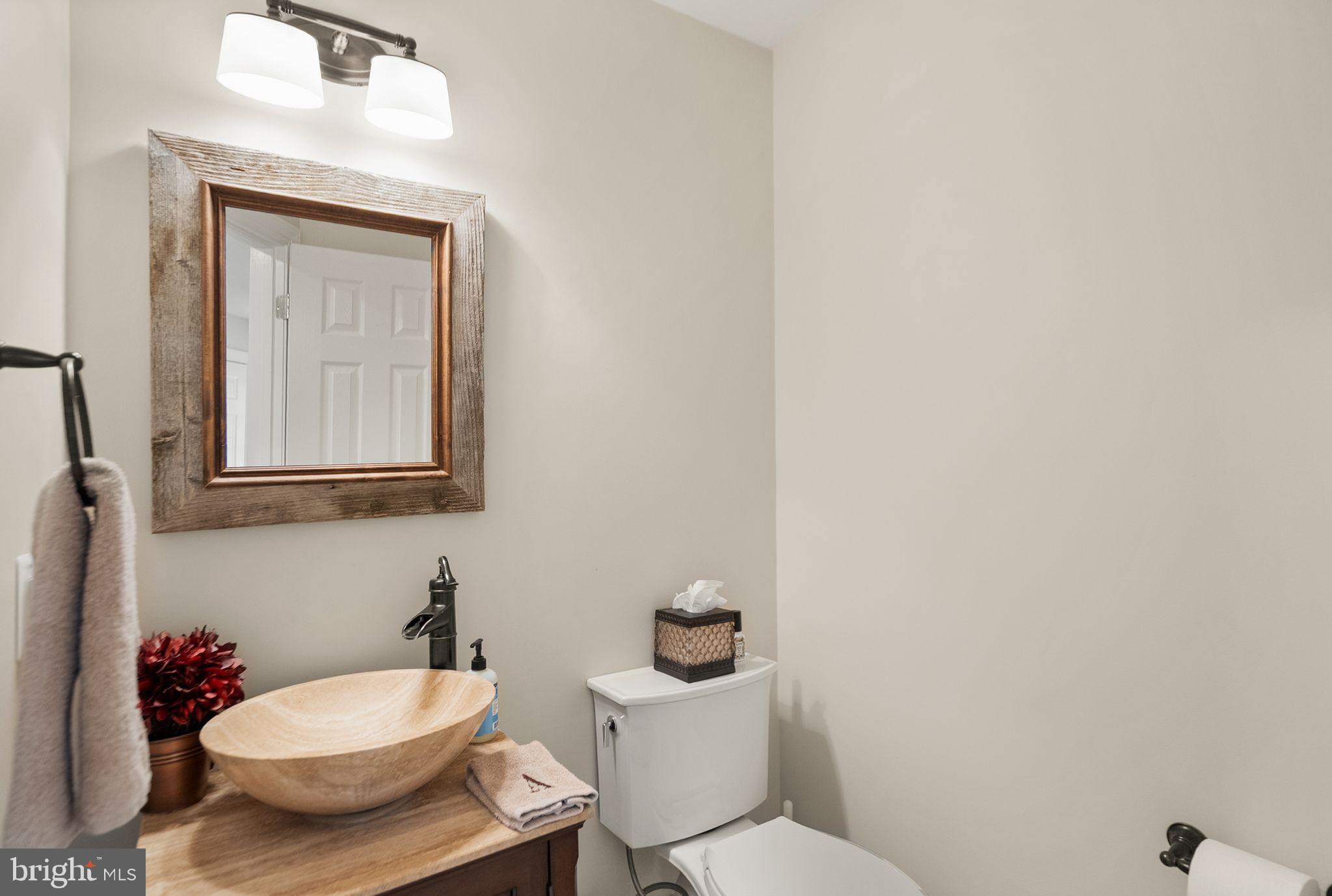 11809 Wayland Street Oakton, VA 22124 - Photo 33 of 97 a bathroom with a toilet a sink and mirror