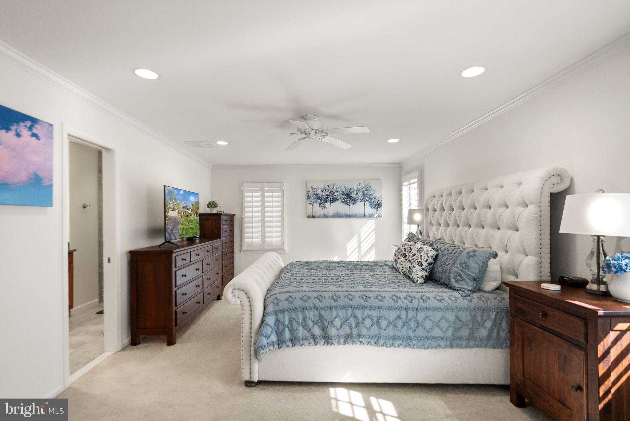11809 Wayland Street Oakton, VA 22124 - Photo 35 of 97 a bedroom with a large bed and a couch