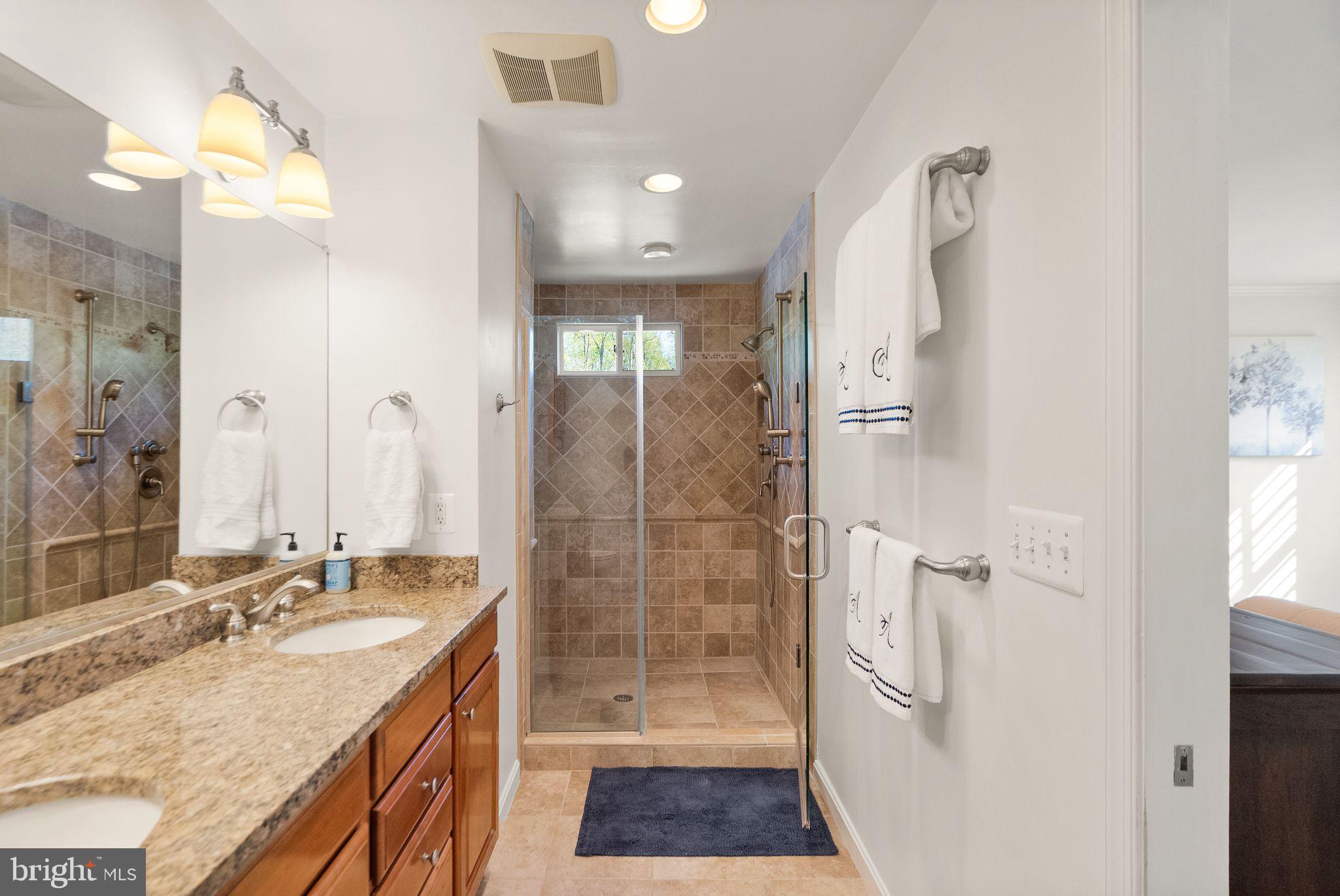 11809 Wayland Street Oakton, VA 22124 - Photo 38 of 97 a bathroom with a granite countertop sink mirror and shower