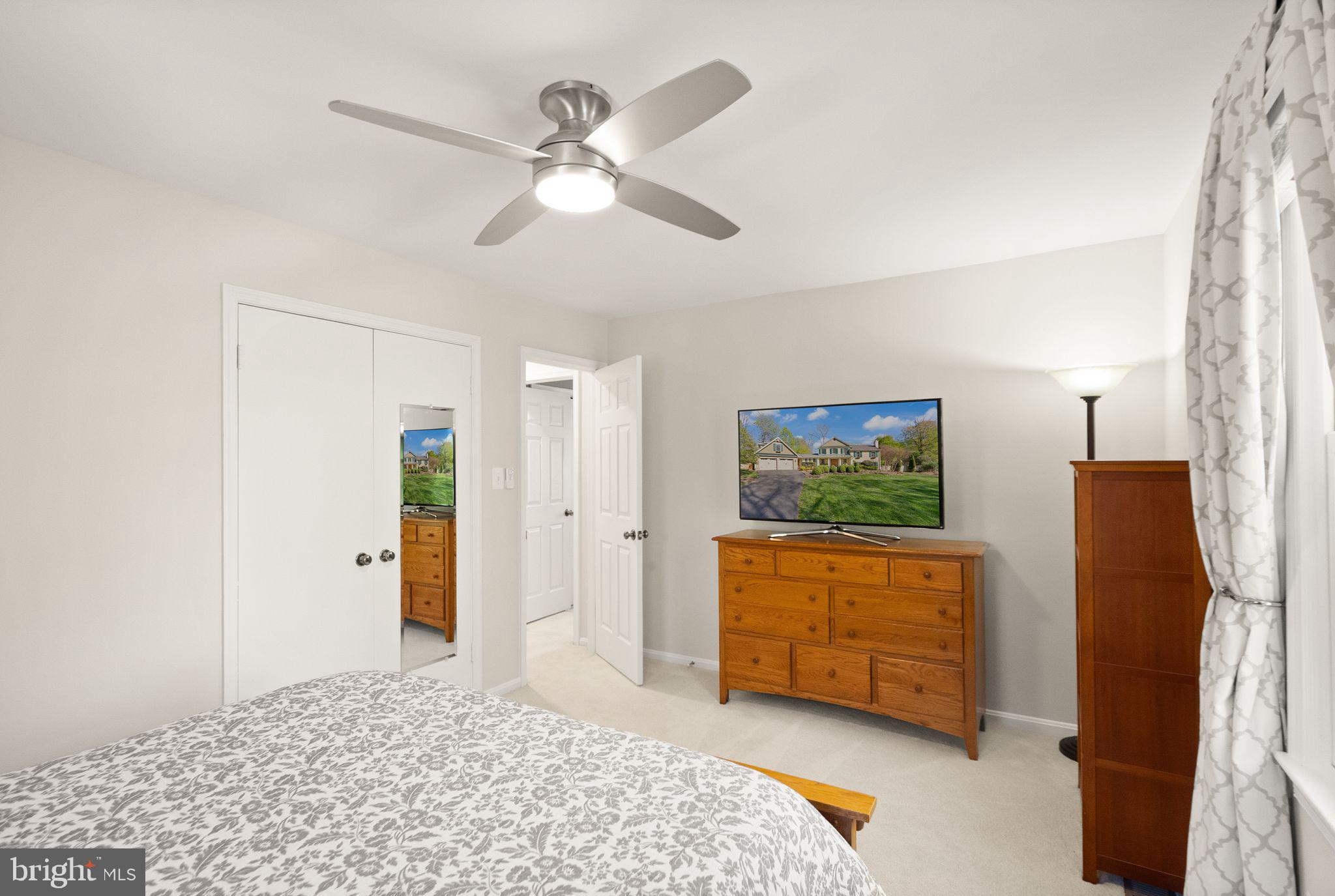11809 Wayland Street Oakton, VA 22124 - Photo 45 of 97 a bedroom with a bed and a flat screen tv