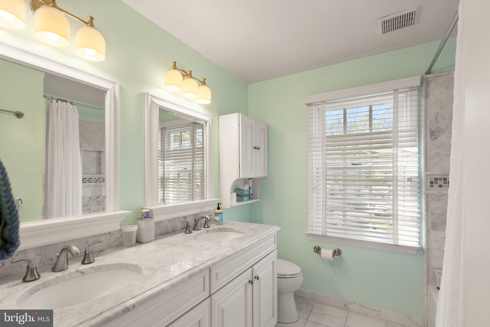 11809 Wayland Street Oakton, VA 22124 - Photo 48 of 97 a bathroom with a granite countertop sink a toilet and a window