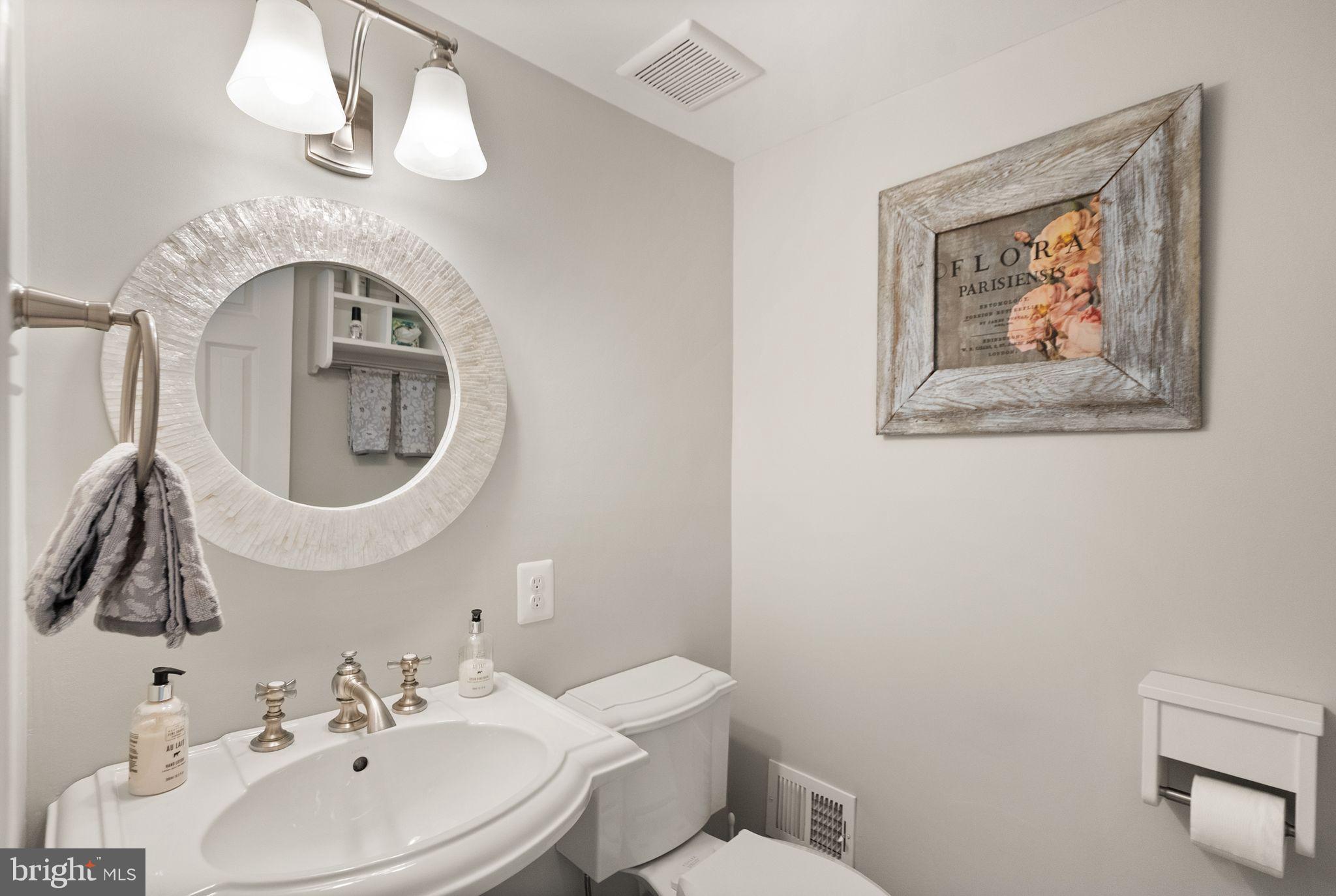 11809 Wayland Street Oakton, VA 22124 - Photo 57 of 97 a bathroom with a toilet a sink and mirror