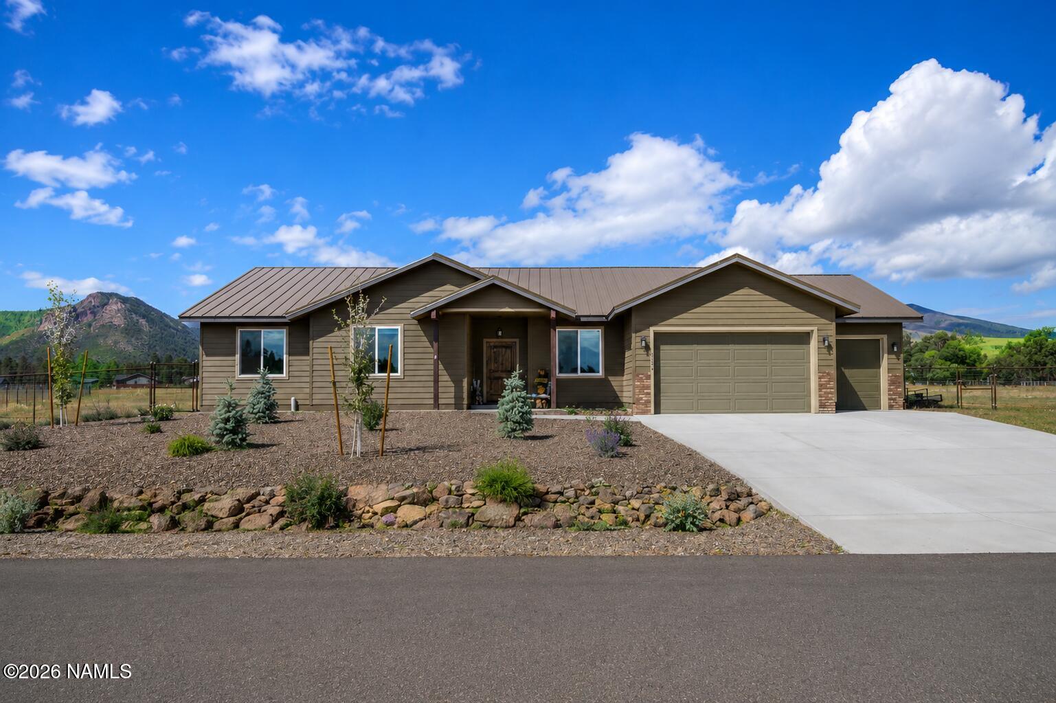 a front view of a house with yard and garage
