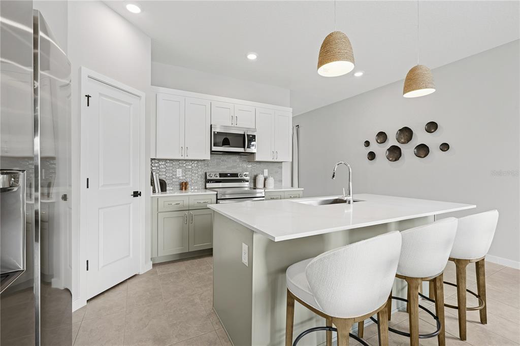 4474 Northwest 37th St Road Ocala, FL 34482 - Photo 10 of 16 a kitchen with stainless steel appliances a sink a table and chairs
