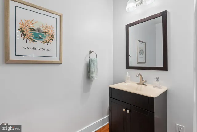 a bathroom with a sink vanity and a mirror