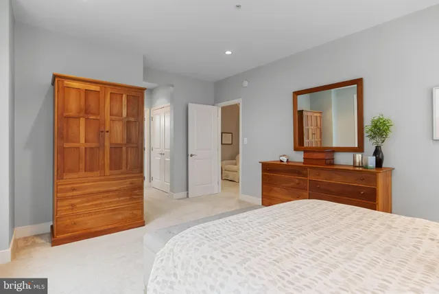 a bedroom with a bed and a dresser