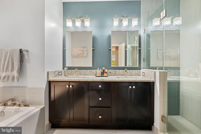 a bathroom with a double vanity sink and a mirror
