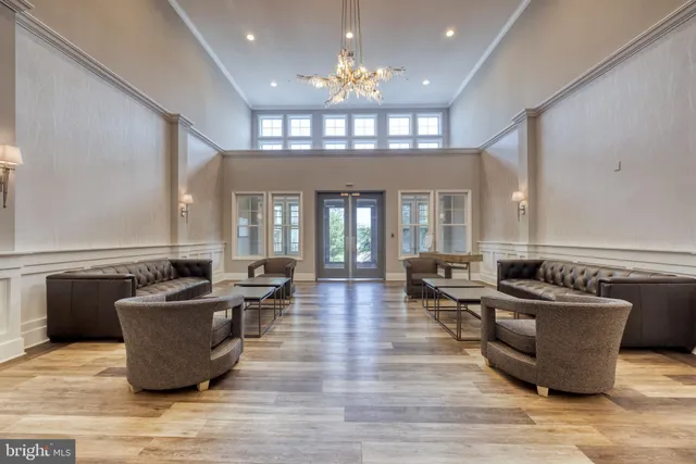 a living room with fireplace furniture and a chandelier