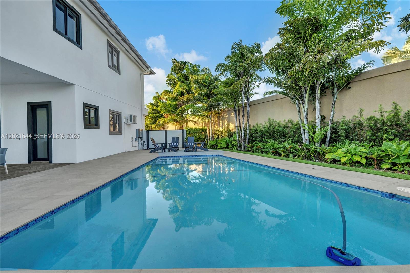 7800 Southwest 9th Terrace Miami, FL 33144 - Photo 11 of 64 a swimming pool with outdoor seating and yard