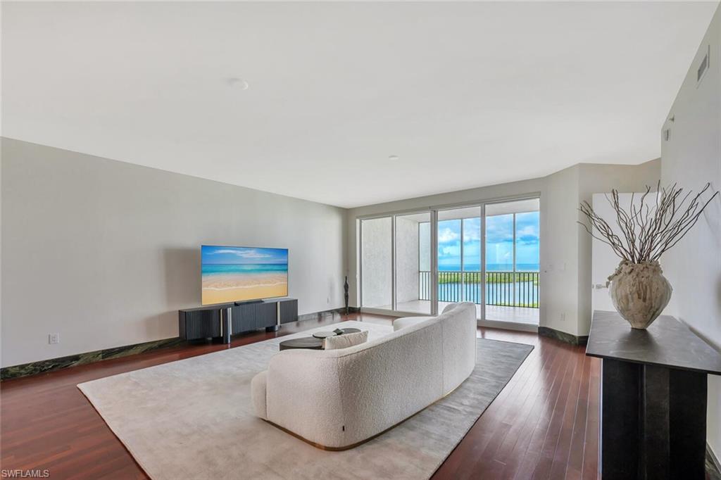 275 Indies Way, Unit 1605 Naples, FL 34110 - Photo 11 of 50 a living room with furniture and a large window