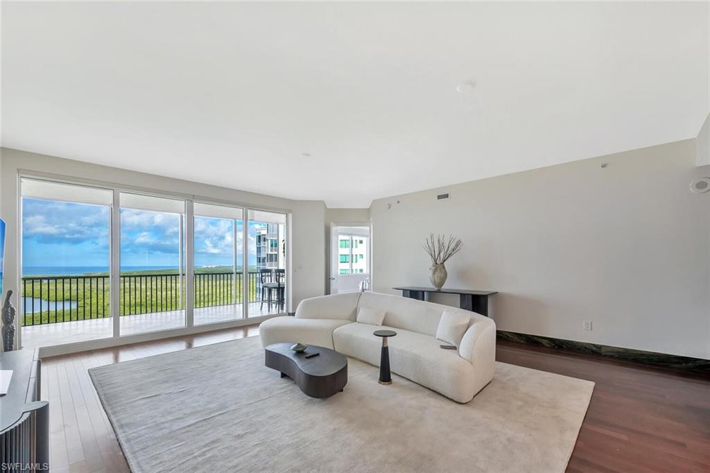 275 Indies Way, Unit 1605 Naples, FL 34110 - Photo 12 of 50 a living room with furniture and a large window