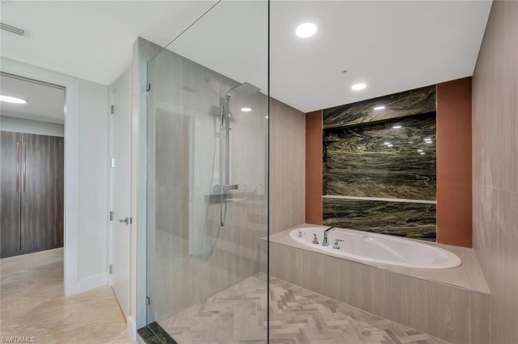 275 Indies Way, Unit 1605 Naples, FL 34110 - Photo 24 of 50 a bathroom with a bathtub and a shower