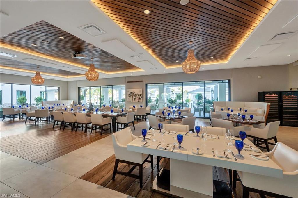 275 Indies Way, Unit 1605 Naples, FL 34110 - Photo 43 of 50 a room with lots of furniture and a large window