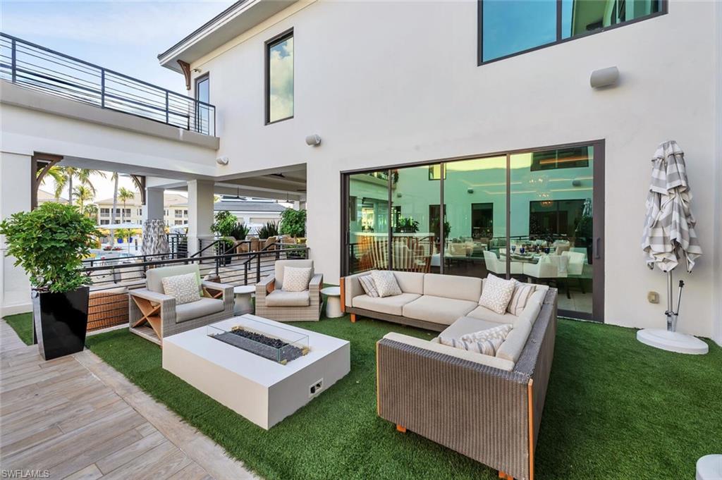 275 Indies Way, Unit 1605 Naples, FL 34110 - Photo 50 of 50 a living room with patio furniture and a large window