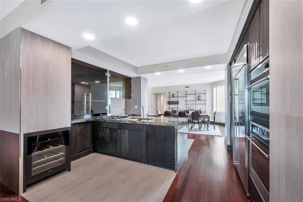 275 Indies Way, Unit 1605 Naples, FL 34110 - Photo 6 of 50 a kitchen with lots of counter top space and stainless steel appliances