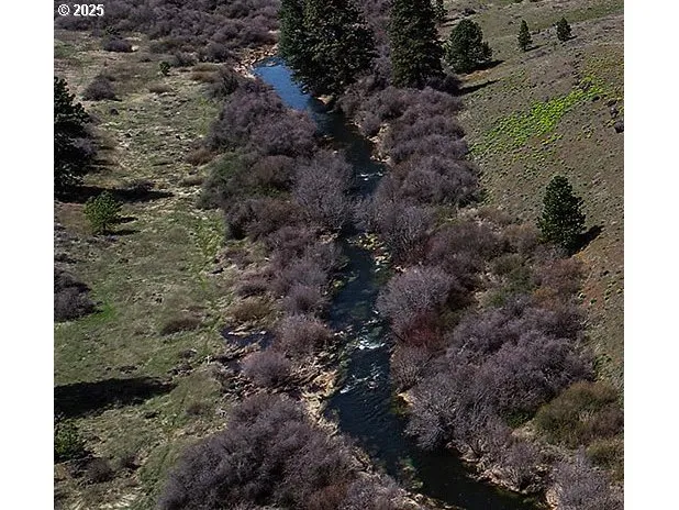 a view of a lake with sunset in background