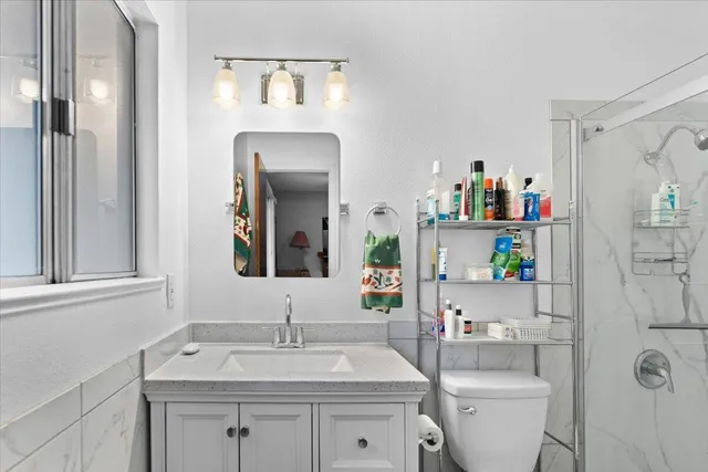 a view of an empty room with wooden floor and closet
