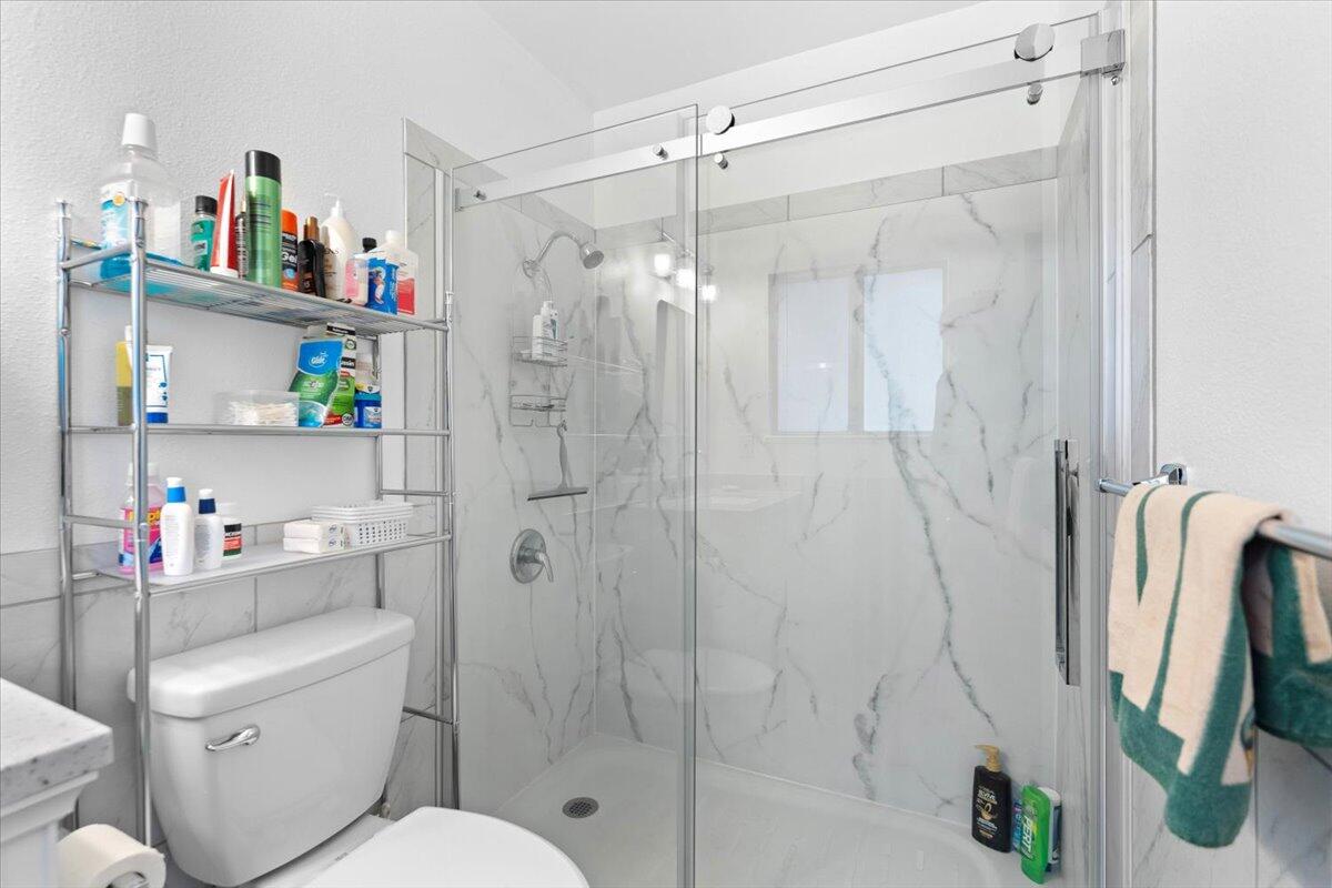 5210 Balls Ferry Road Anderson, CA 96007 - Photo 16 of 68 a bathroom with a shower toilet and a sink