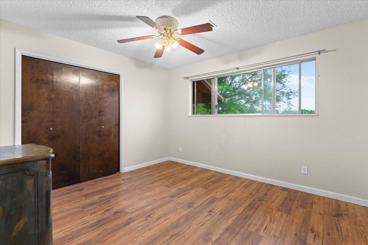 5210 Balls Ferry Road Anderson, CA 96007 - Photo 20 of 68 a view of empty room with wooden floor and fan