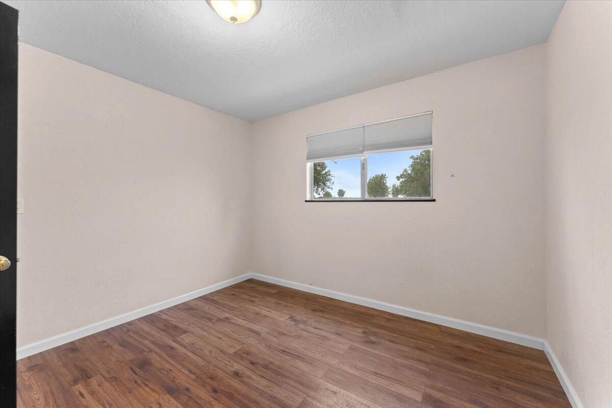 5210 Balls Ferry Road Anderson, CA 96007 - Photo 25 of 68 wooden floor in an empty room with a window