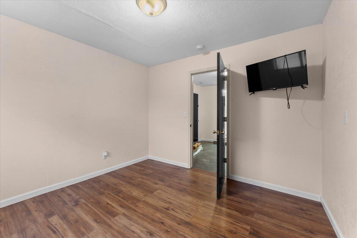 5210 Balls Ferry Road Anderson, CA 96007 - Photo 26 of 68 a view of empty room with wooden floor and fan