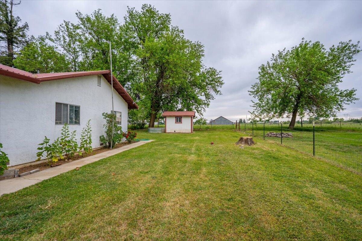5210 Balls Ferry Road Anderson, CA 96007 - Photo 27 of 68 a view of a house with a backyard and a tree