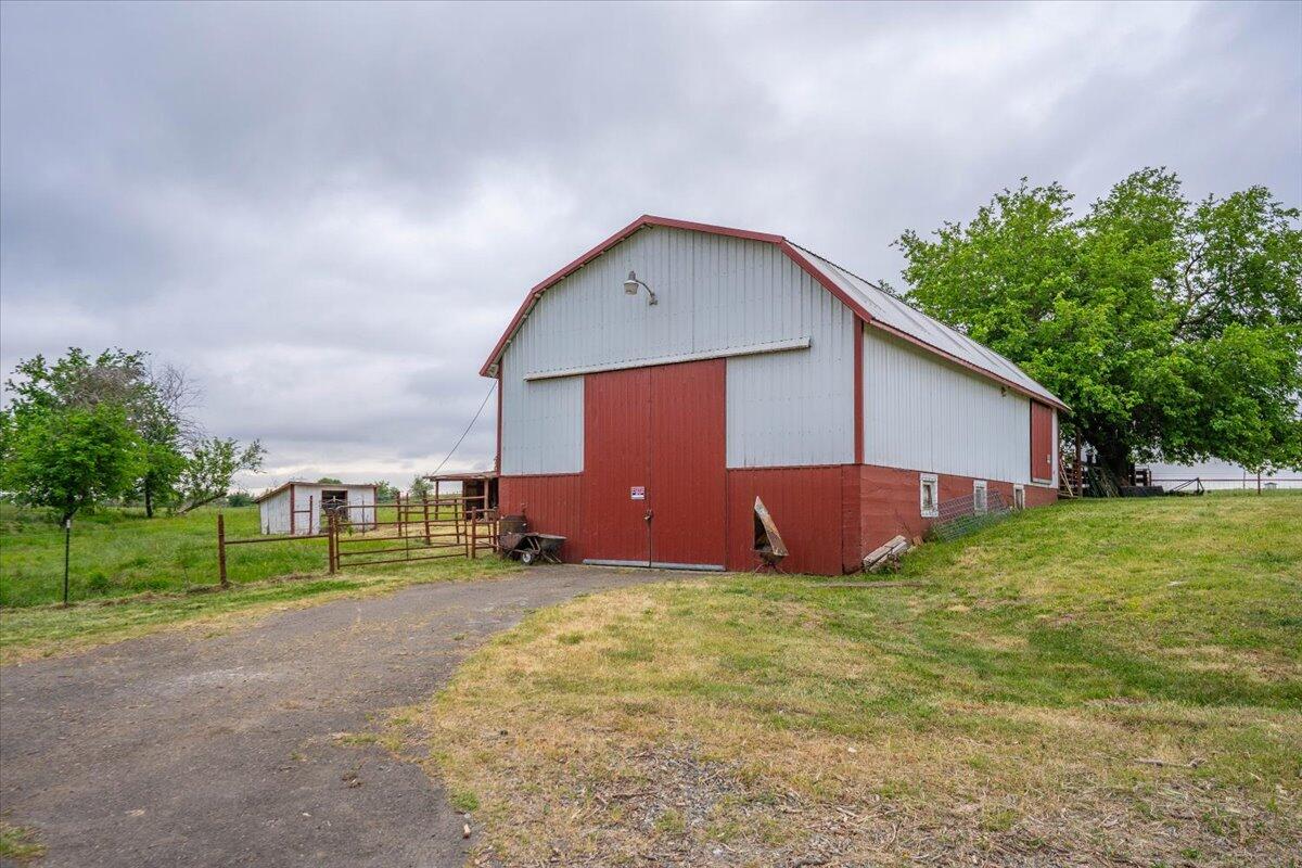 5210 Balls Ferry Road Anderson, CA 96007 - Photo 32 of 68 a view of a house with a yard and a large tree