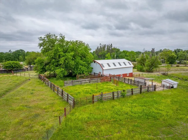 a backyard of a house with table and chairs