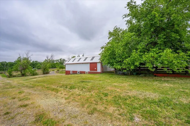 a view of a big yard with large trees
